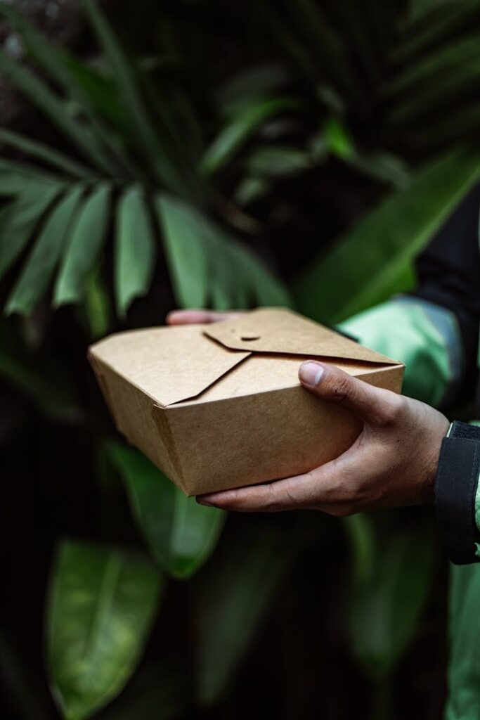 Close-up of Man Holding a Box with Food